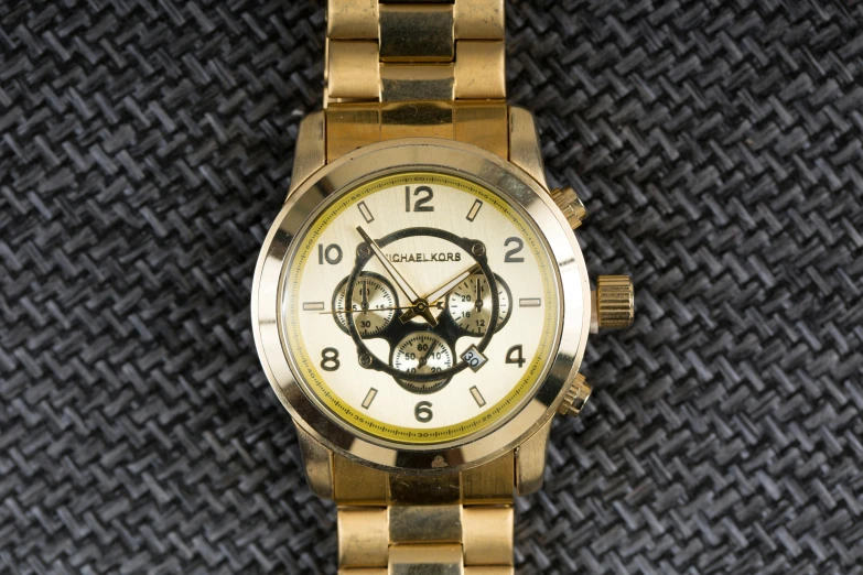 a gold watch that has the numbers 8 on it