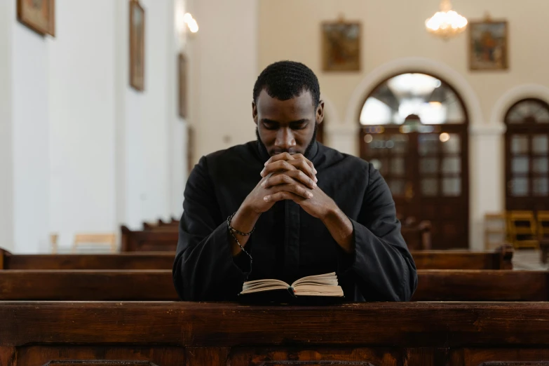 the priest is looking down on his book