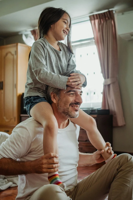 a man sitting on top of a woman's shoulders