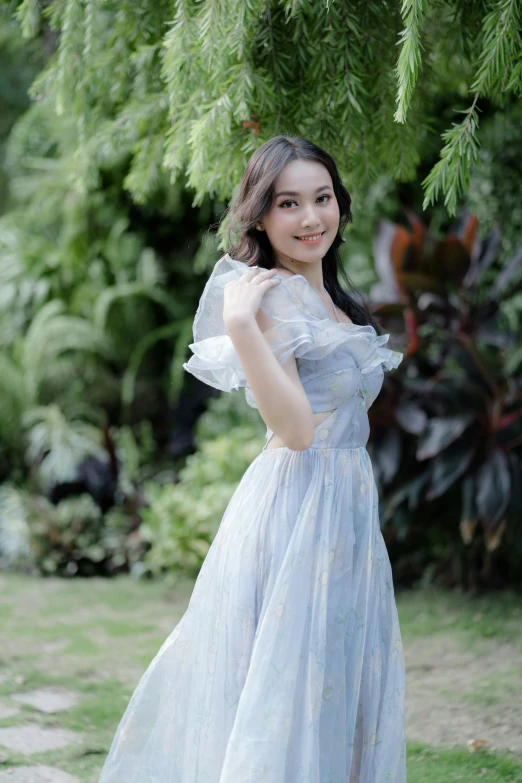 an asian girl in blue dress posing