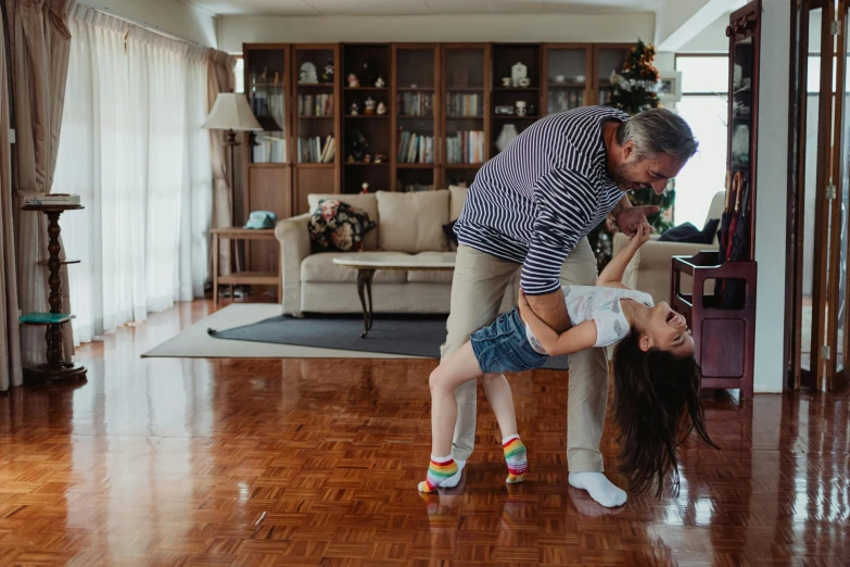 an adult helping a  put on her shoes