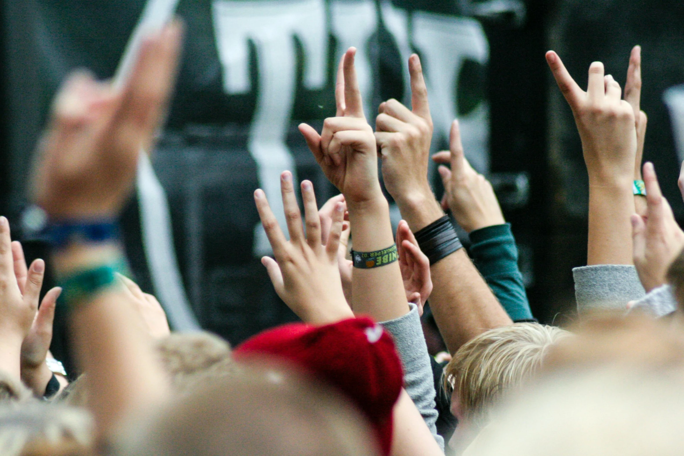 a group of people raising their hands in the air