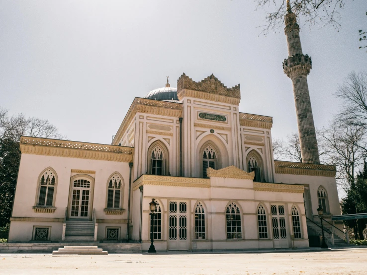 an old white and yellow building with large windows