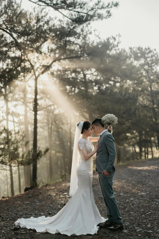 a newlywed couple in their wedding day pose for a po