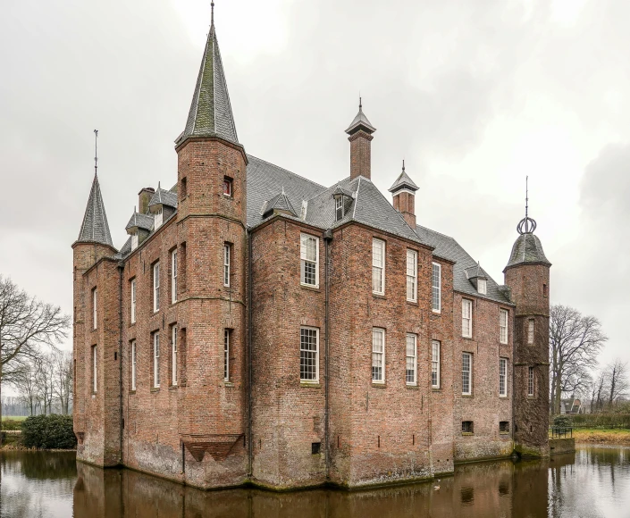 an old brick building stands in water by some trees