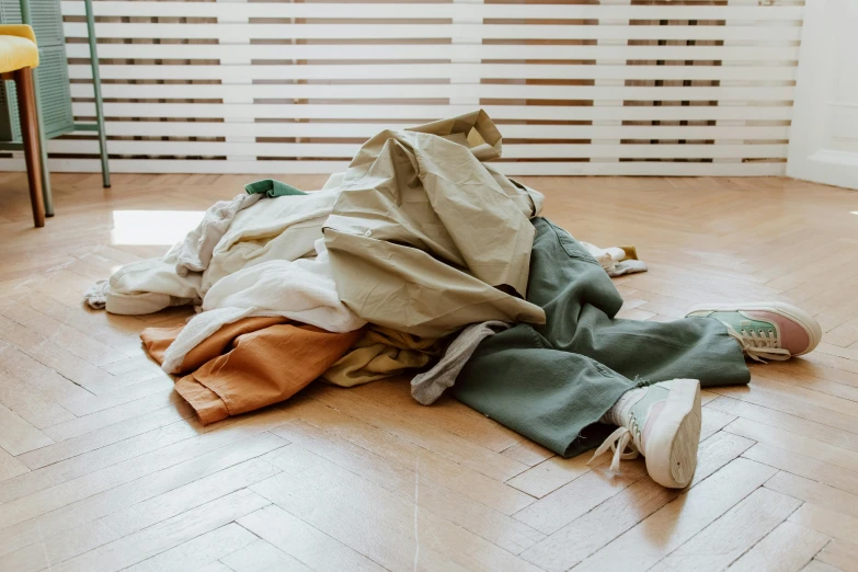 a group of clothes sitting on top of a wooden floor