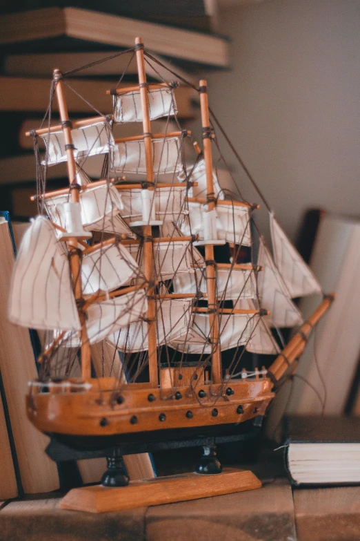 a large model ship sitting on a wooden base