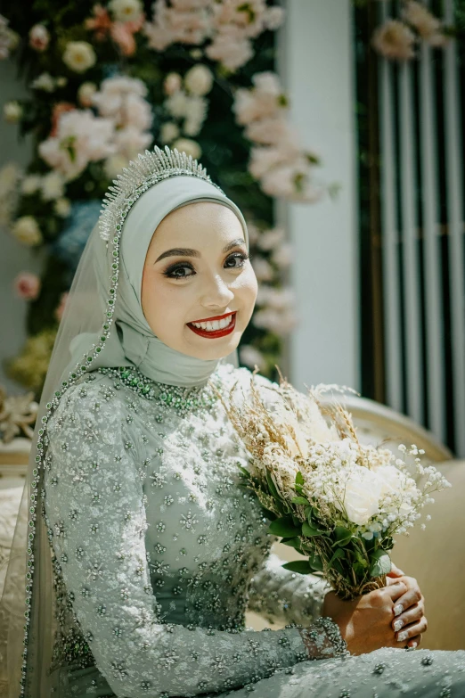 an asian woman dressed in wedding gown posing