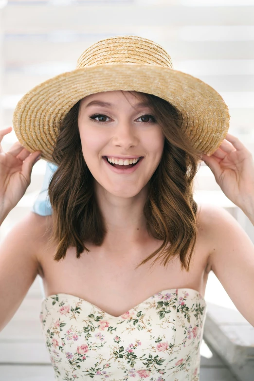 a girl with a straw hat is smiling