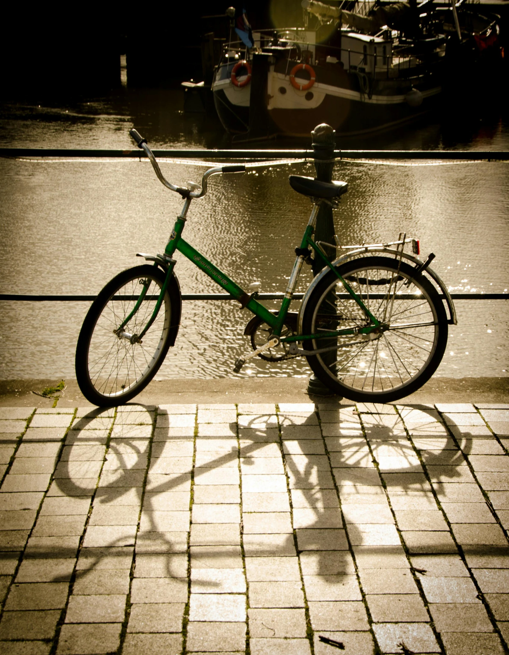 a bike is parked on the sidewalk beside a brick street