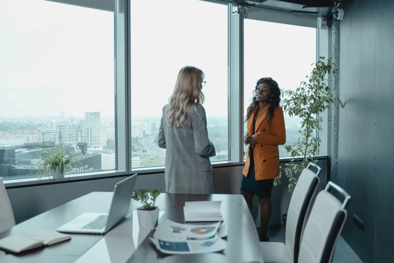 two women look out over an empty room