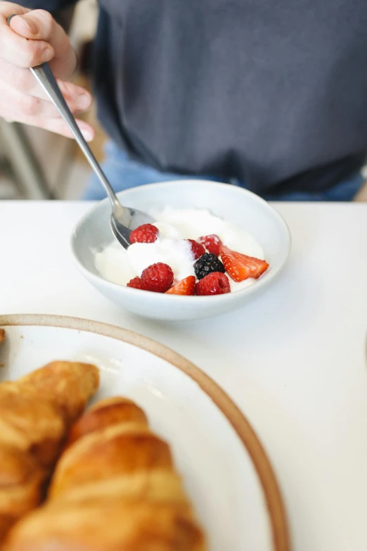 a person taking a bite of some fruit