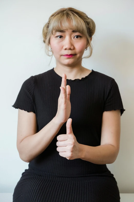 a woman making a sign on her fingers