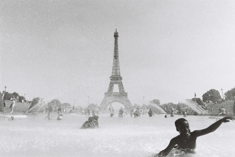 people enjoying a day of surfing in the surf near the eiffel tower