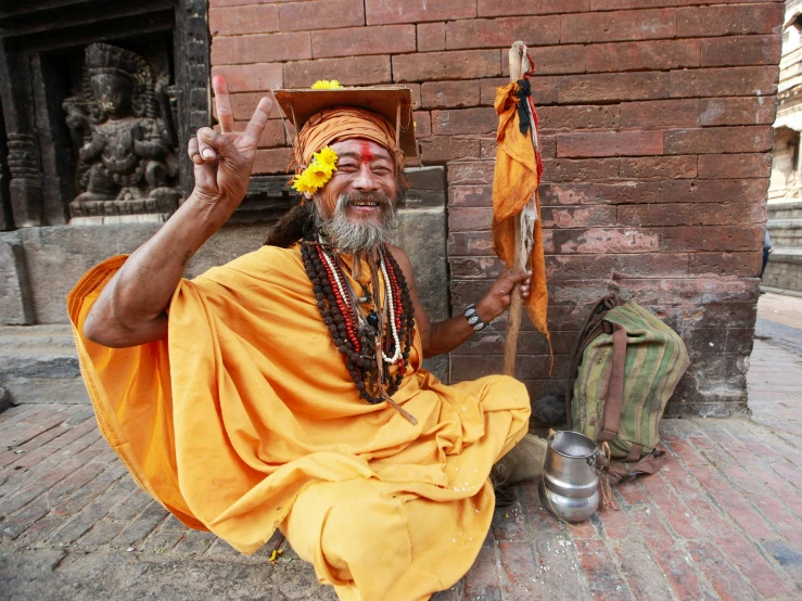 an old man dressed in a costume with a yellow hat