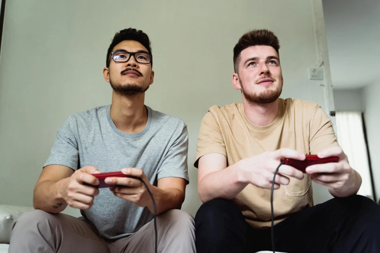 a couple of men sitting on top of a couch