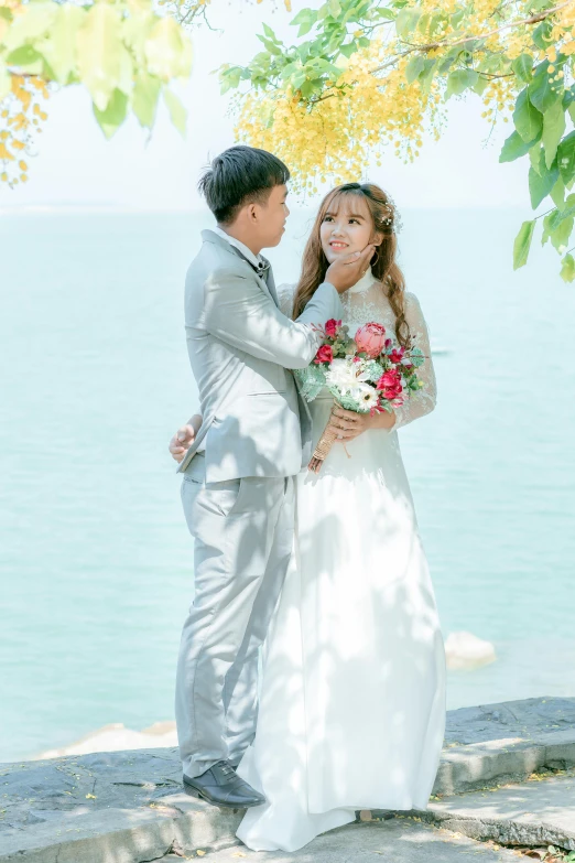 a young bride and groom by the sea