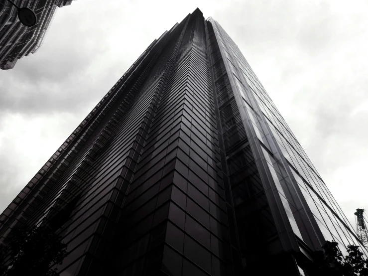 an upward view of a tall building with many windows