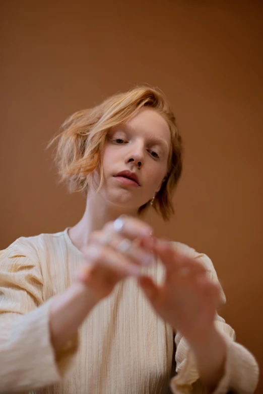 a woman in a white dress holding a glass