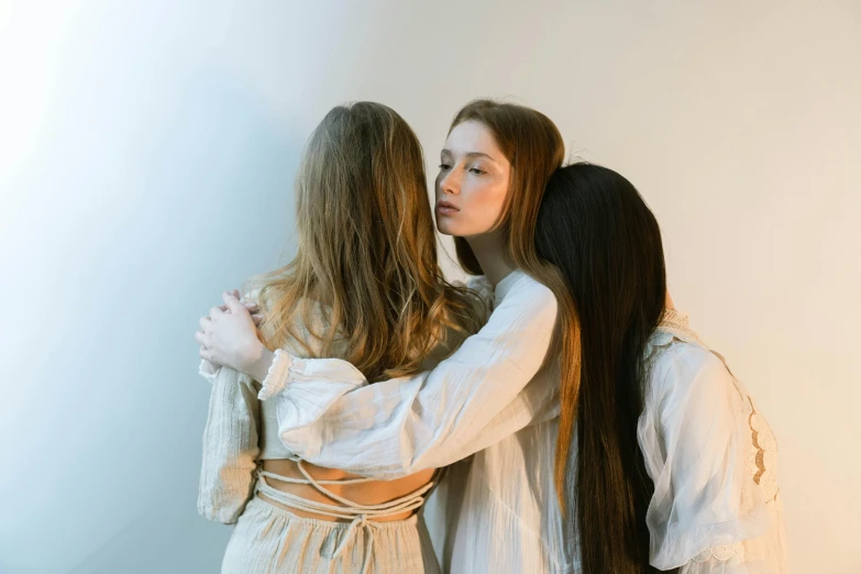 two women are standing together in a room