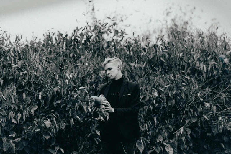 a man is in front of an overgrown field