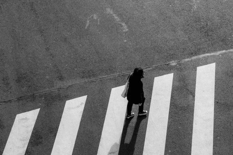 an aerial view of a person crossing the street