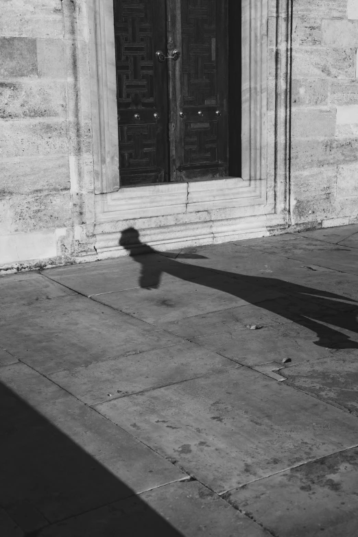 a shadow of a person with a cane