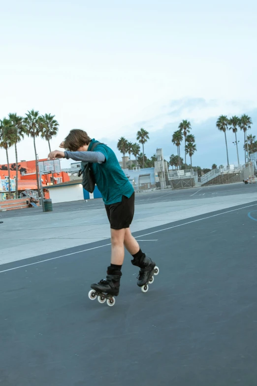 a skateboarder is riding down the road on his board