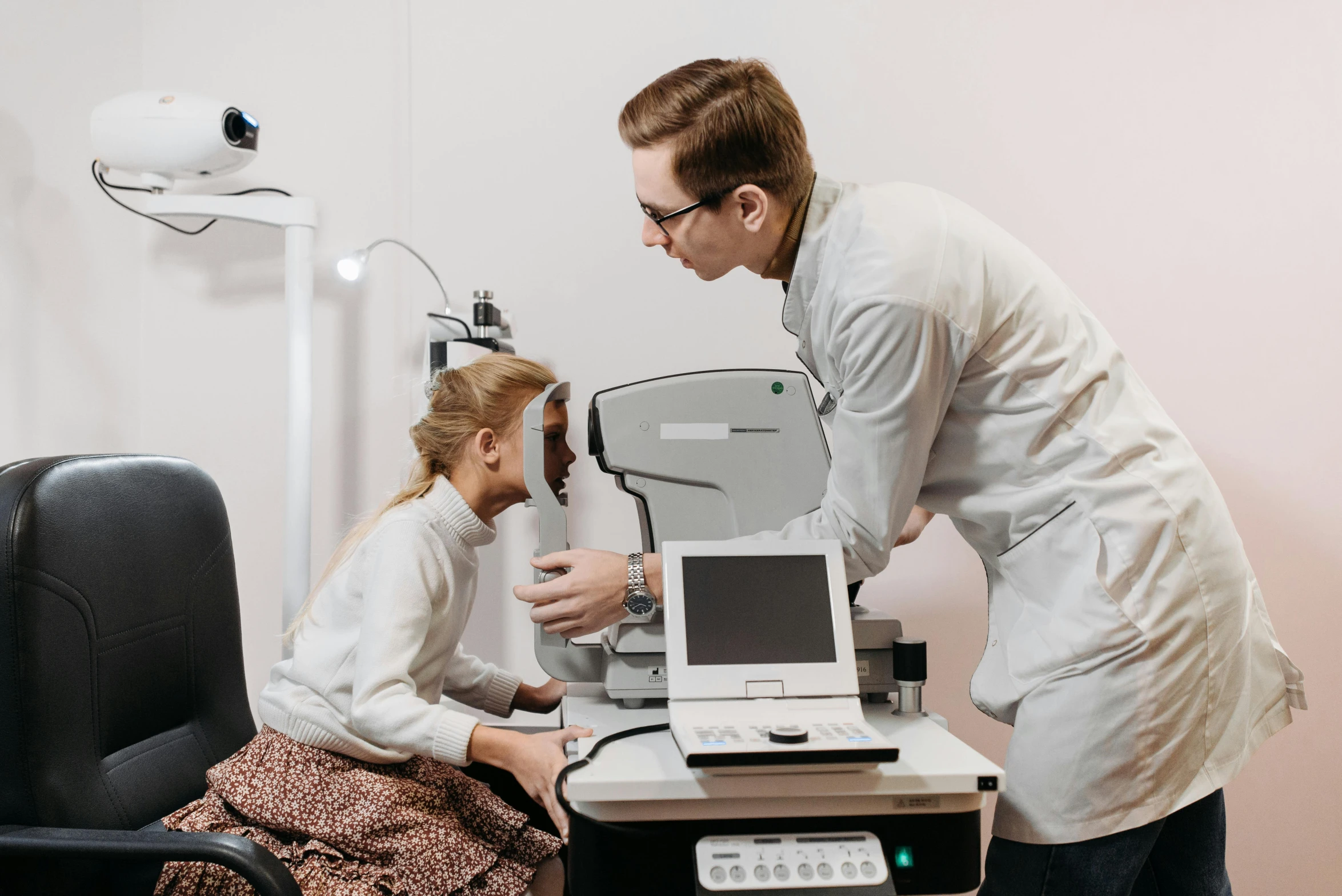 a girl is getting help with a doctor's equipment