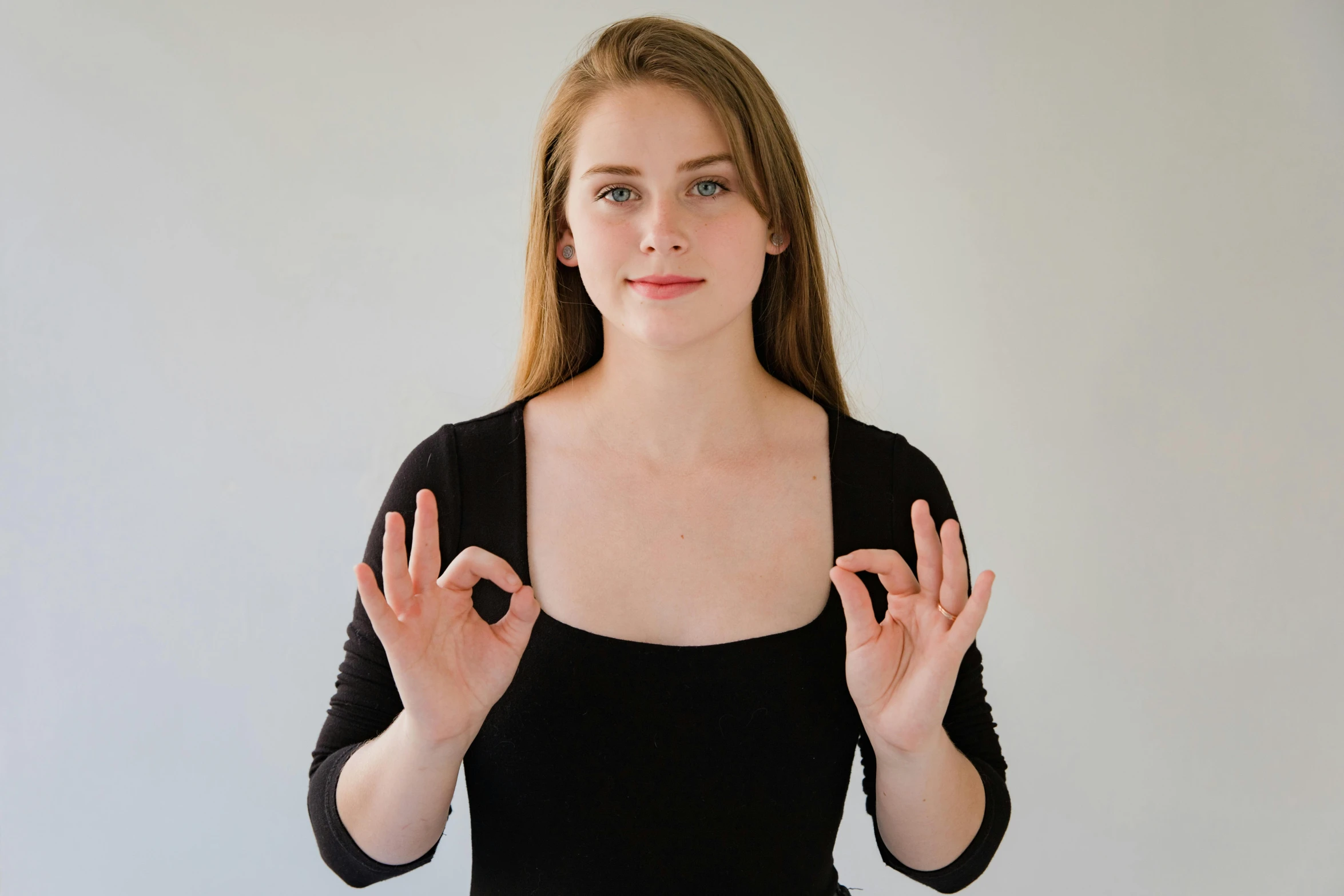 woman in black shirt holding her hands up
