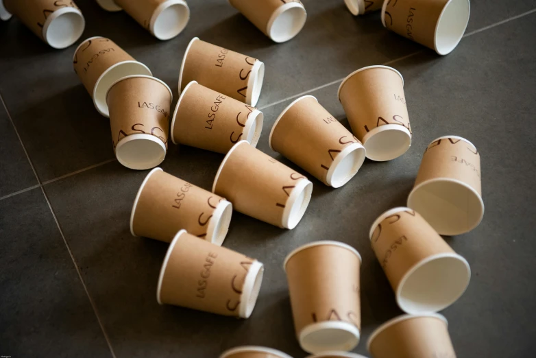 small cups are placed on the floor as part of a presentation