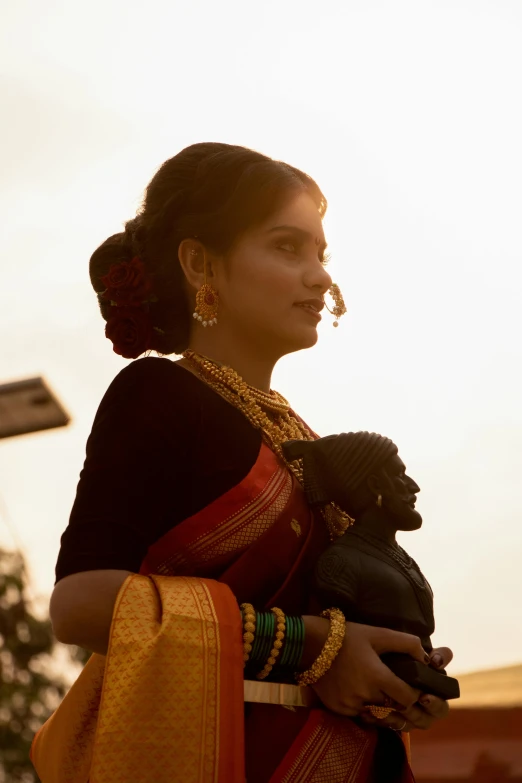 woman in dress holding animal at outdoor event