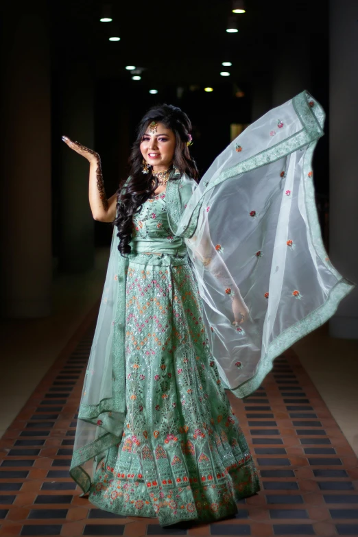 a woman dressed in a gown holds up an umbrella