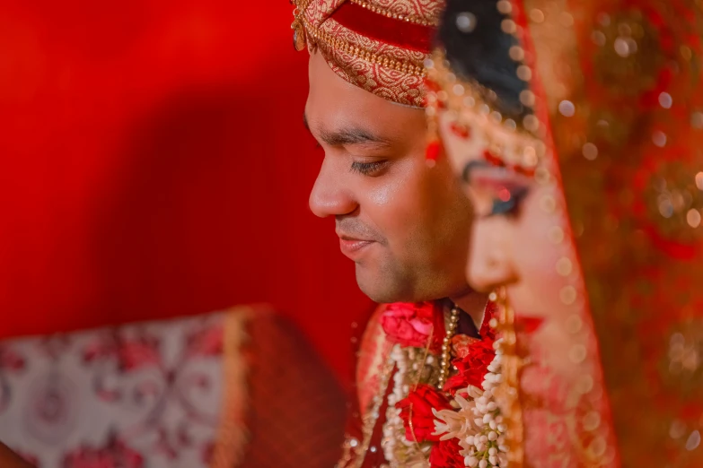 a man and woman in red and gold attire