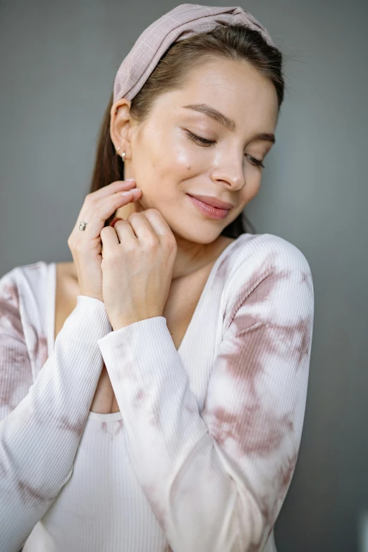 a woman poses for a po with her hands on her chin