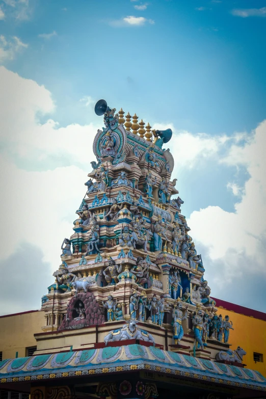 large tower made of clay with many gadgets and sculptures on top