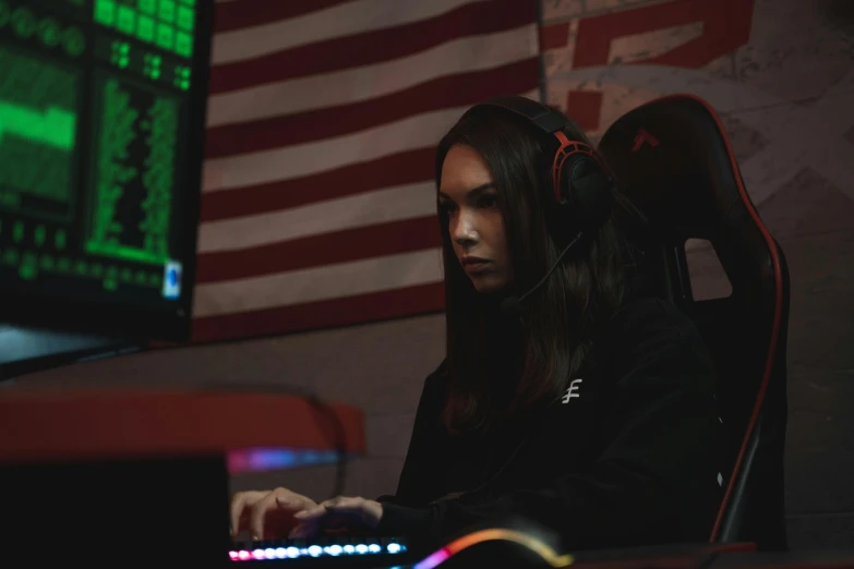 the woman sitting at a computer in front of a monitor