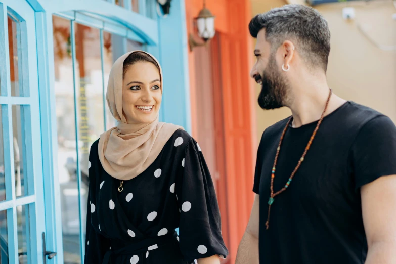 a smiling woman with her husband in a black top