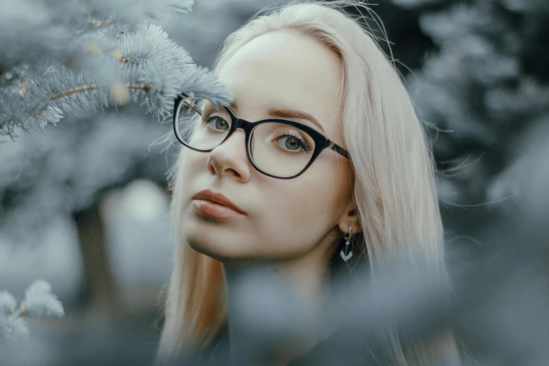 a woman with big  looking out through tree nches