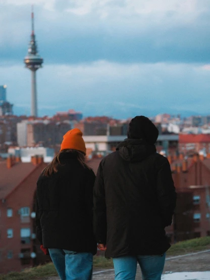 two people standing by each other looking at the view