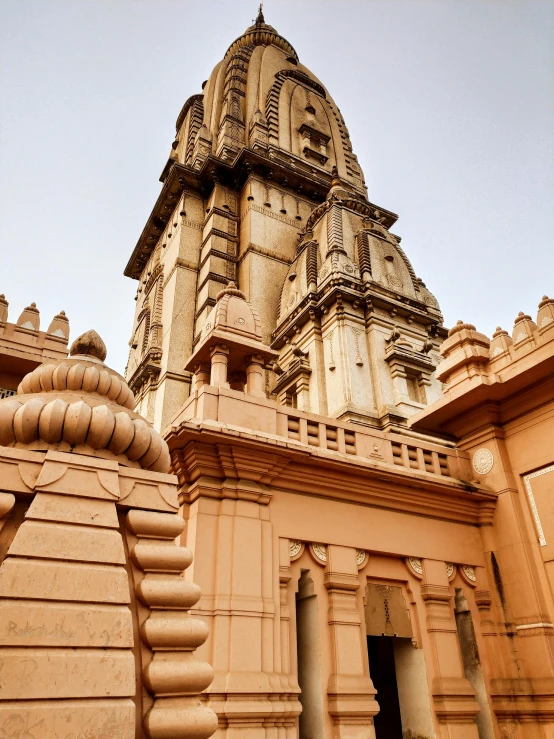 a tan colored castle style building with tall towers