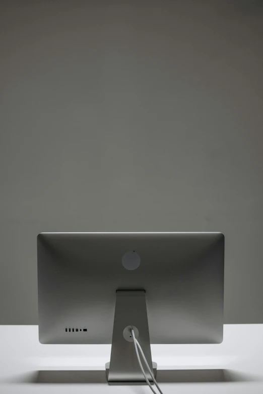 the back end of a laptop on a white desk