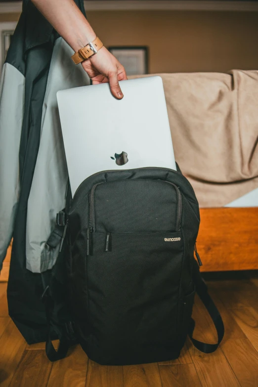 a man holding a laptop in his hand