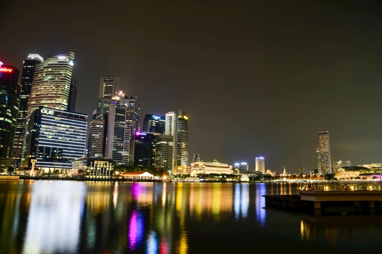 the city skyline is lit up at night