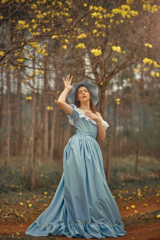 a woman wearing a blue dress is dancing