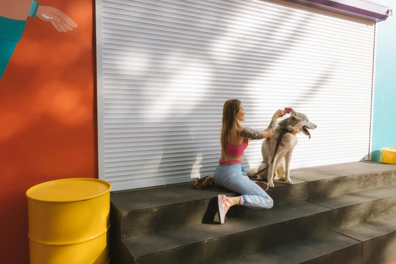 girl grooming the dog with her high heeled shoes