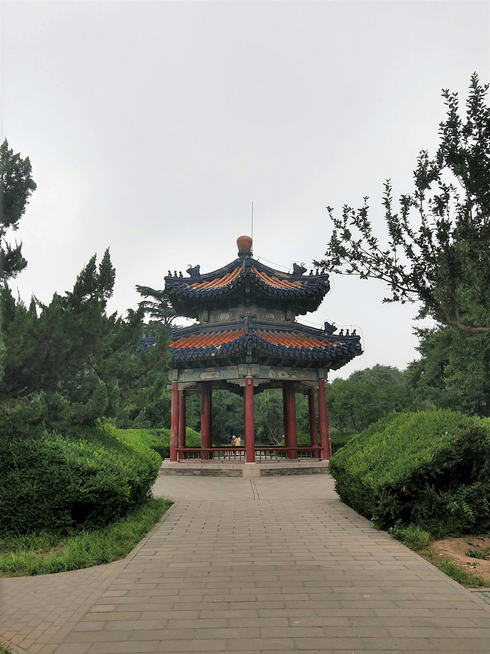 a brick path leads into a pavilion with towers