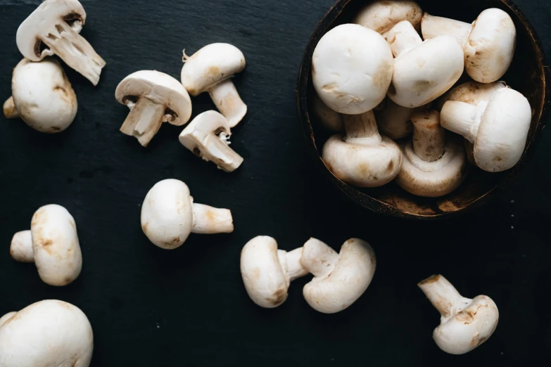 fresh mushrooms are being peeled and eaten with a knife