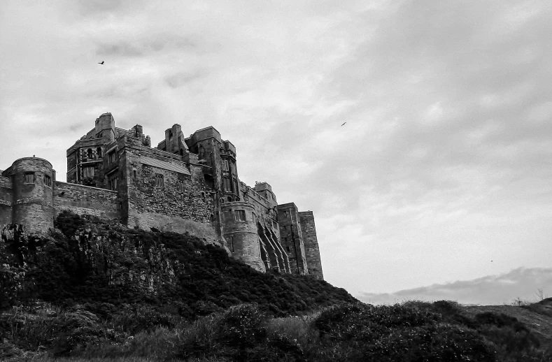 an ancient castle sitting on top of a hill