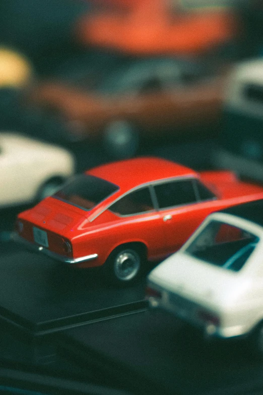 some red cars are parked in a black table